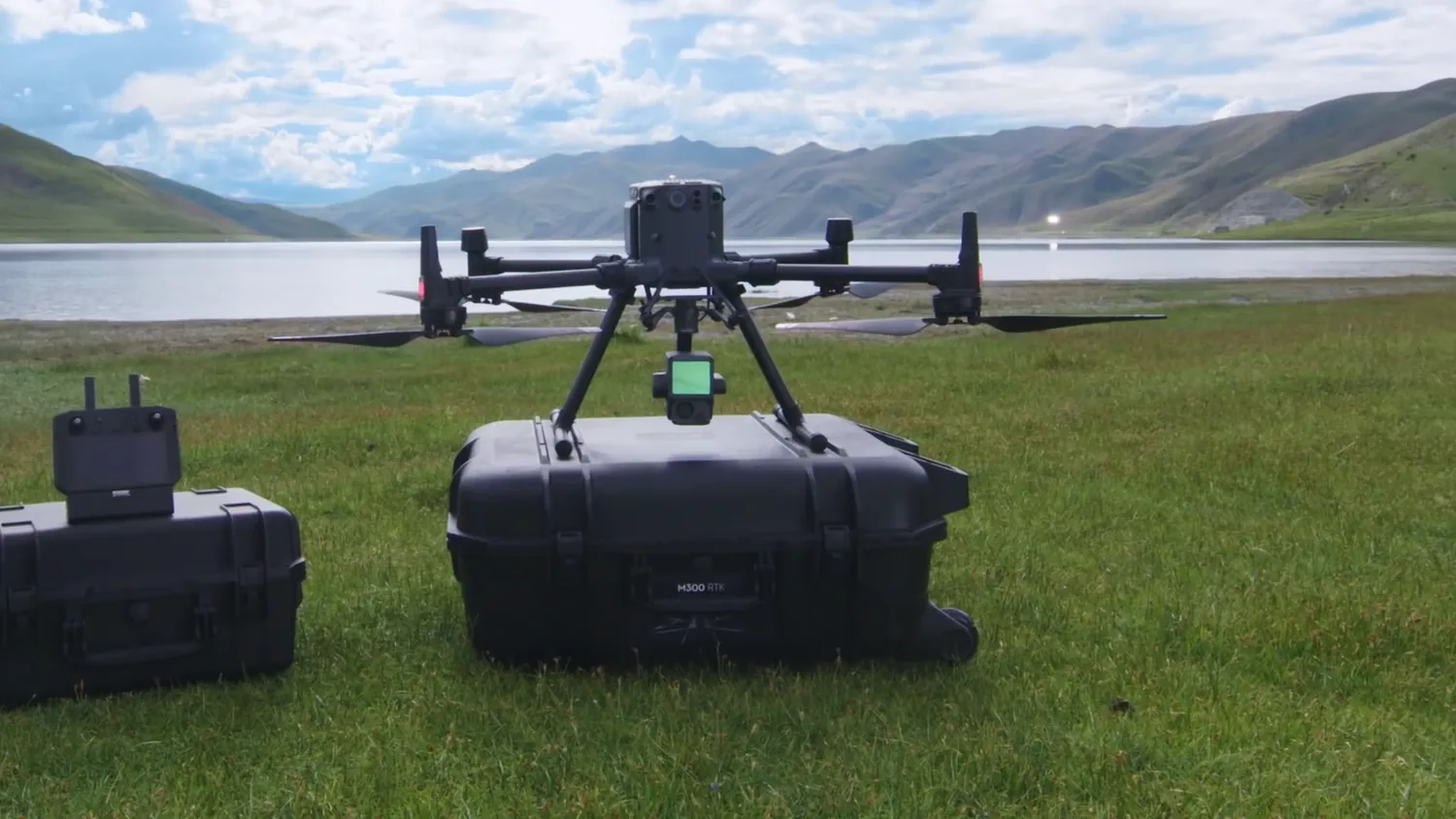 DJI Matrice 350 set up beside rugged transport cases by a lake before deployment
