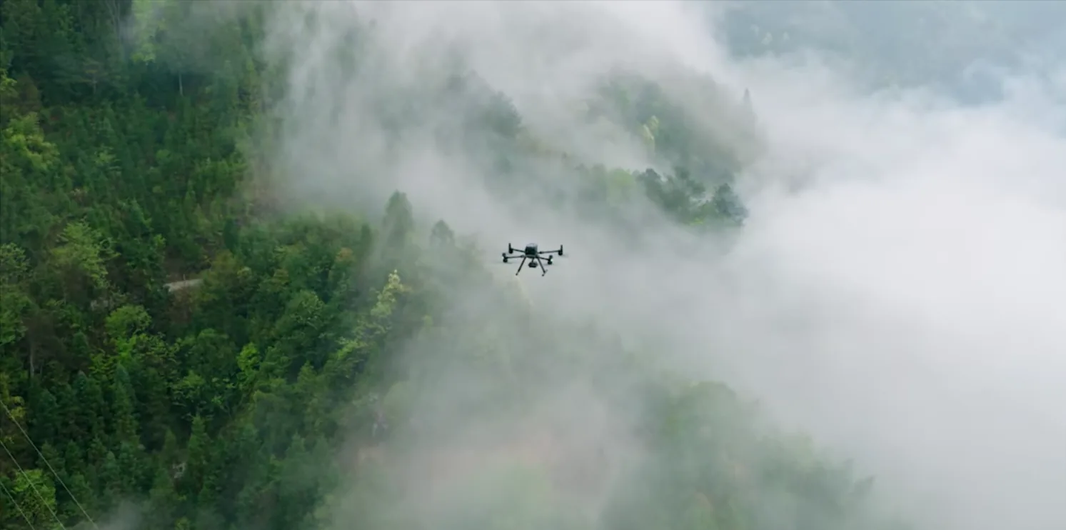 Survey drone executing a mission over misty Costa Rican forest