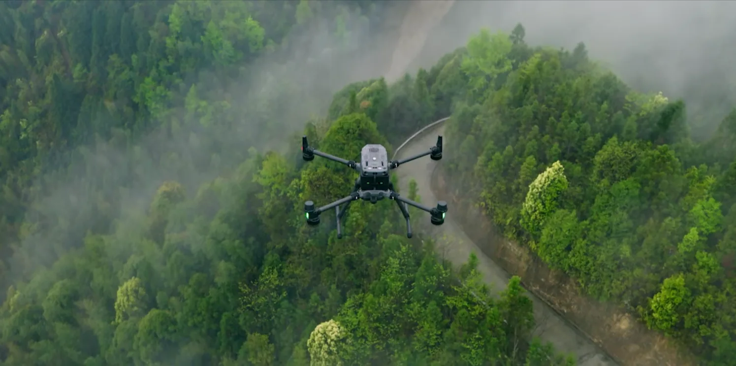 Survey drone flying above a lush misty Costa Rican forest with a river winding through it
