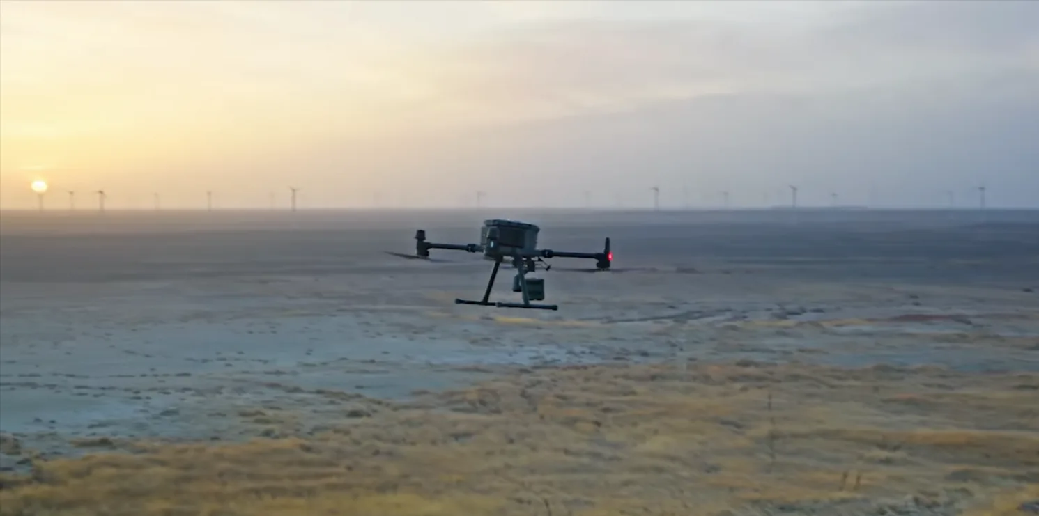 Survey drone flying over a wind farm at golden dawn in Costa Rica